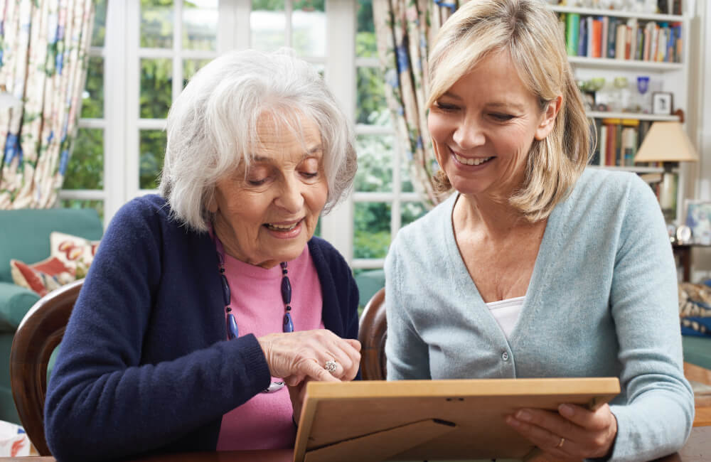 senior looking at a framed photo