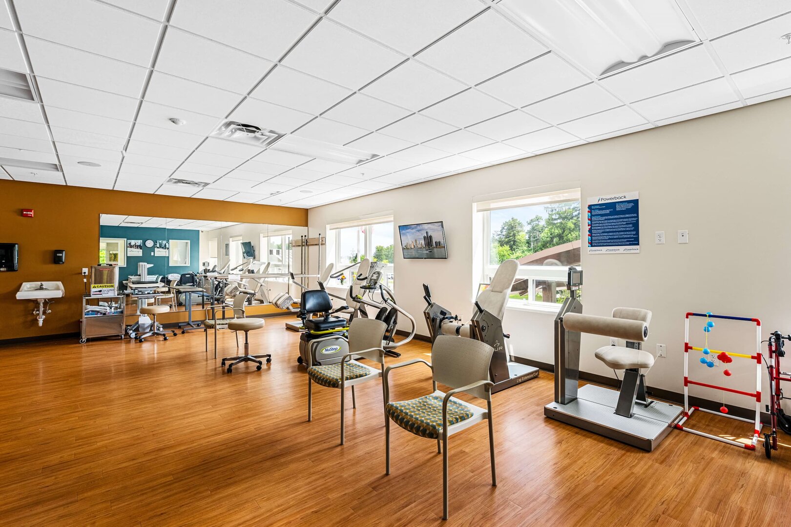 exercise-room-senior-living Exercise room with equipment and chairs in a senior living community.