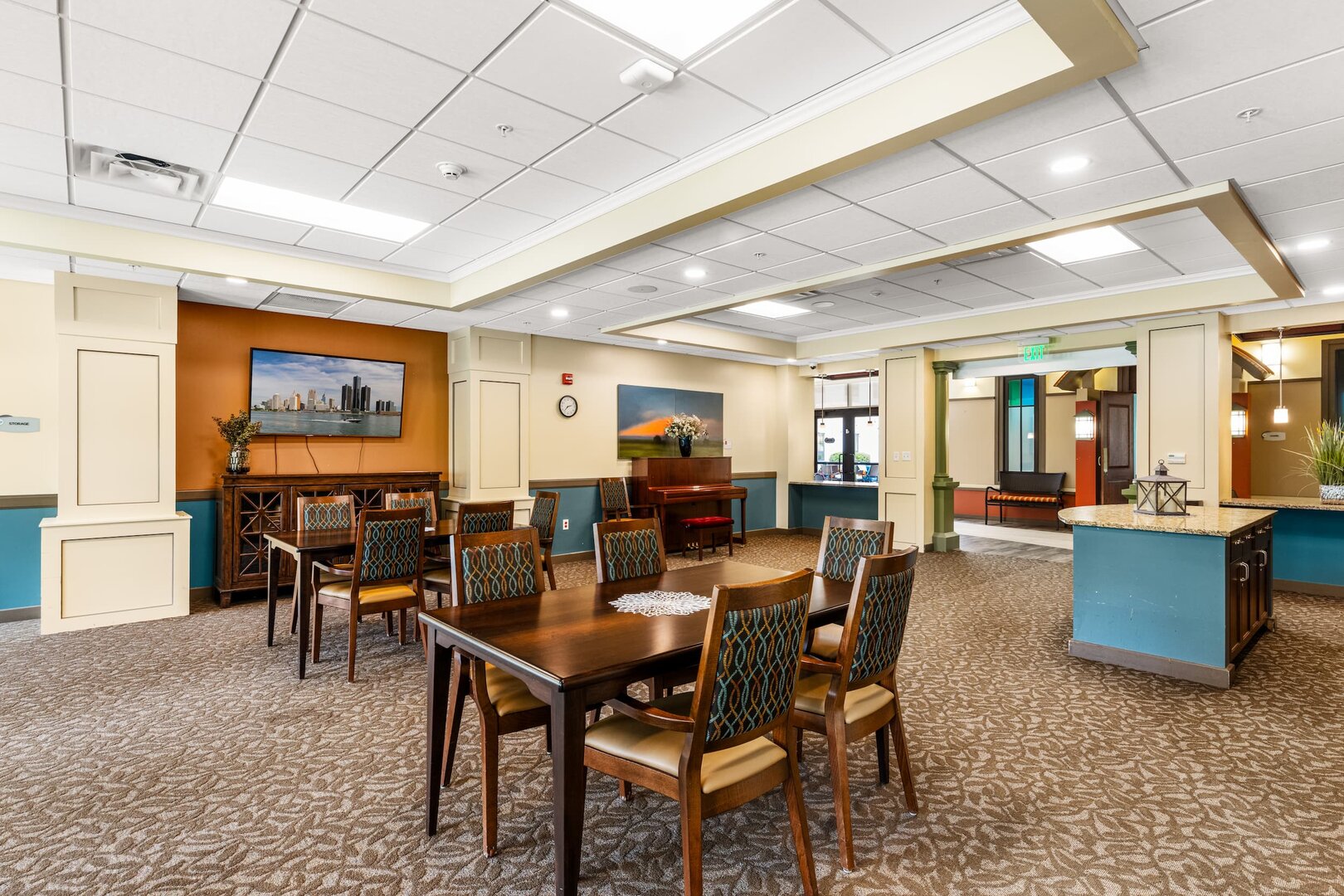 senior-living-community-common-room Bright common area with tables and chairs in a senior living community.