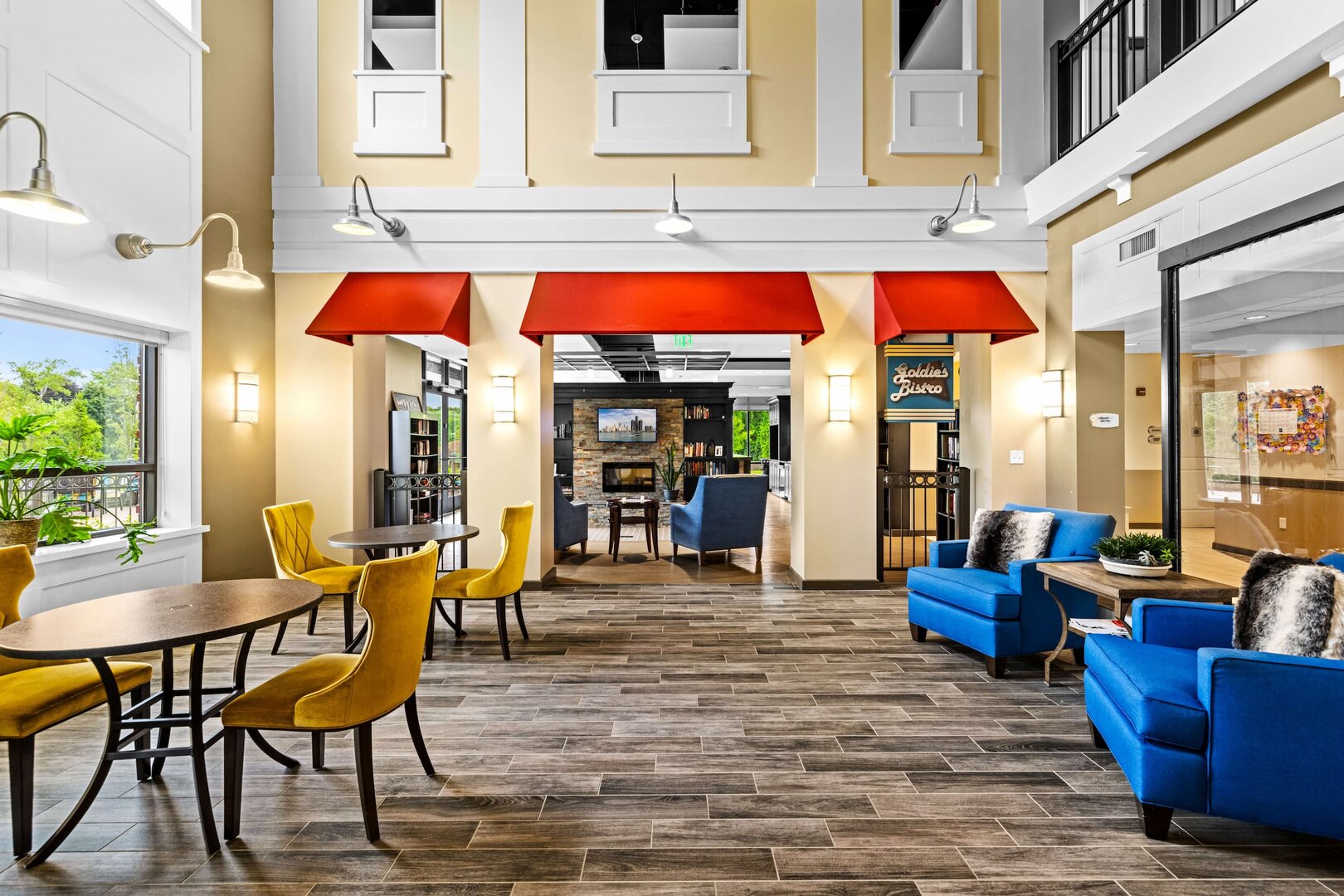 vibrant-communal-area-residential-community-b-04 Brightly colored communal space with seating and tables in a residential community.