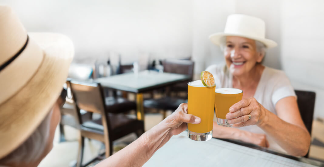seniors clinking drinks together in cheers