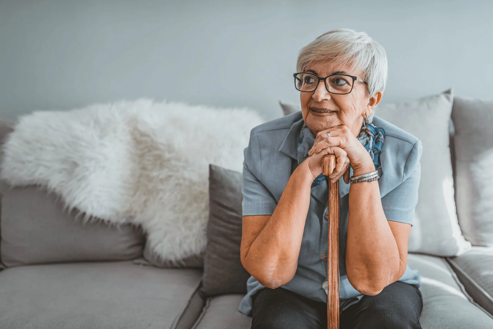 senior-woman-leaning-on-cane-1.jpg women leaning on her walking cane