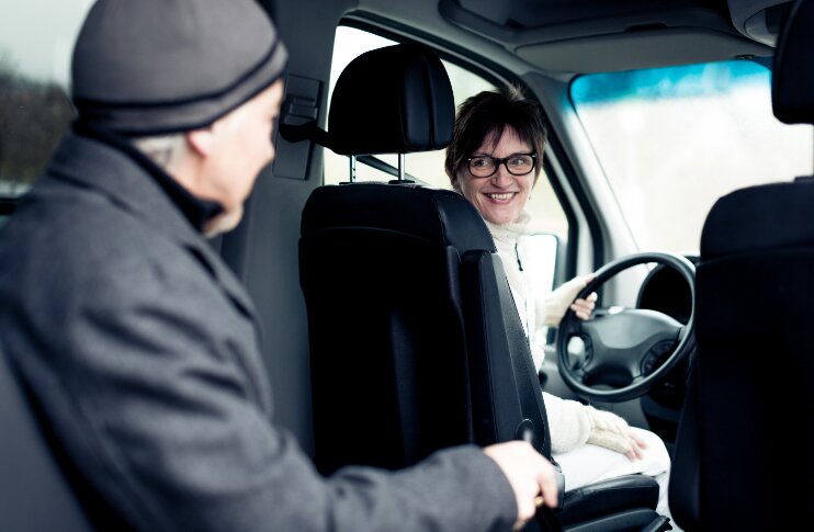 driver woman driving senior man