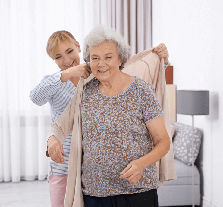 helping-senior-put-on-sweater (1) helping a senior woman put on a sweater